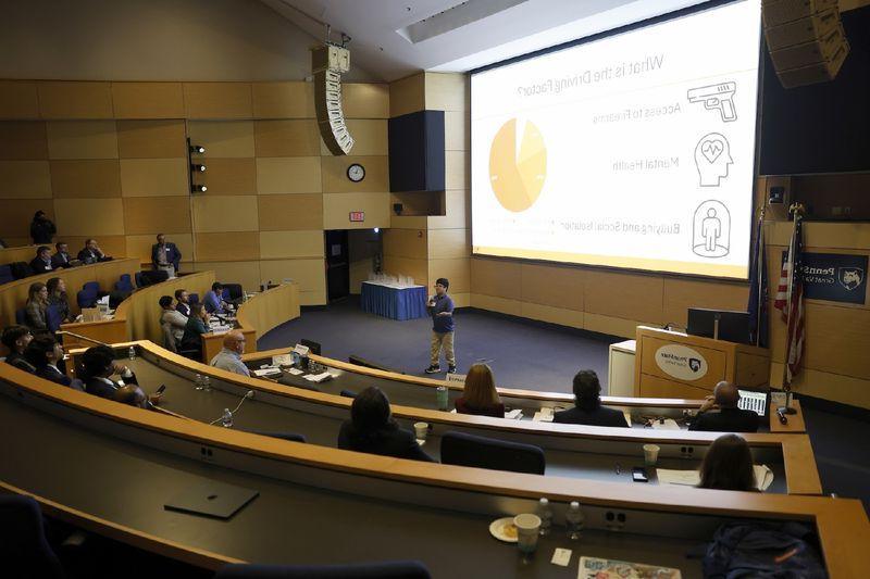 person speaking in front of a crowd